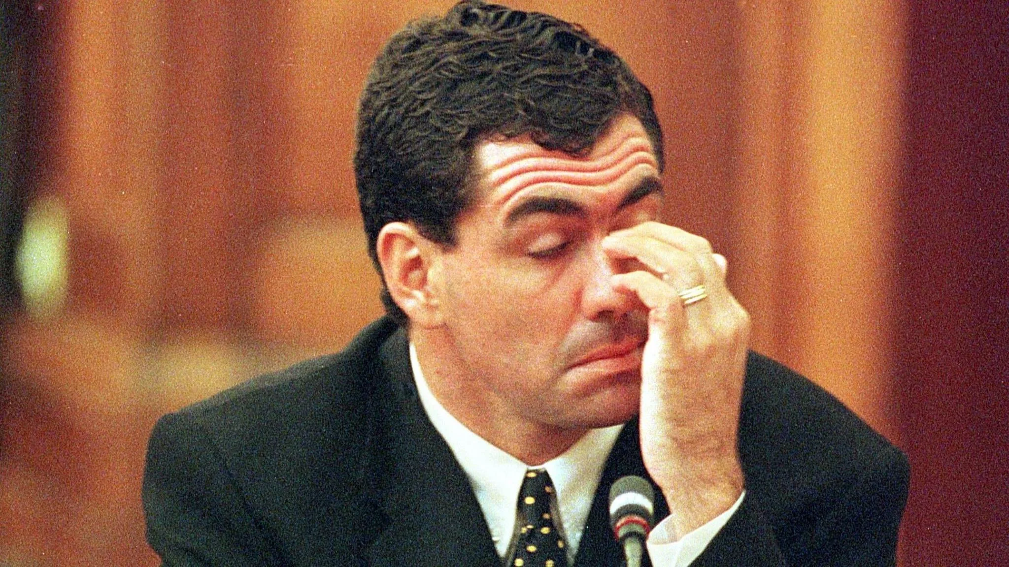 Sacked South African cricket captain Hansie Cronje wipes his eye during his cross-examination at the King Commission of Inquiry into allegations of cricket match-fixing in Cape Town 23 June 2000. Cronje later broke down and left the hearings in tears at the conclusion of his testimony