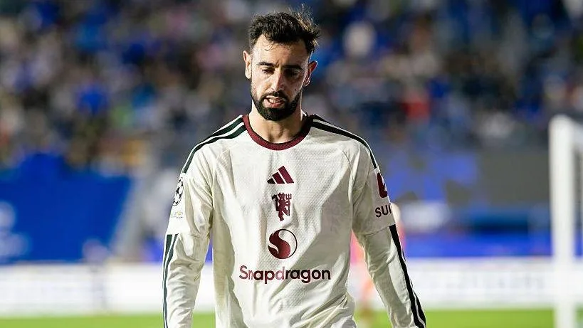 Bruno Fernandes looking dejected, while wearing a Manchester United away strip