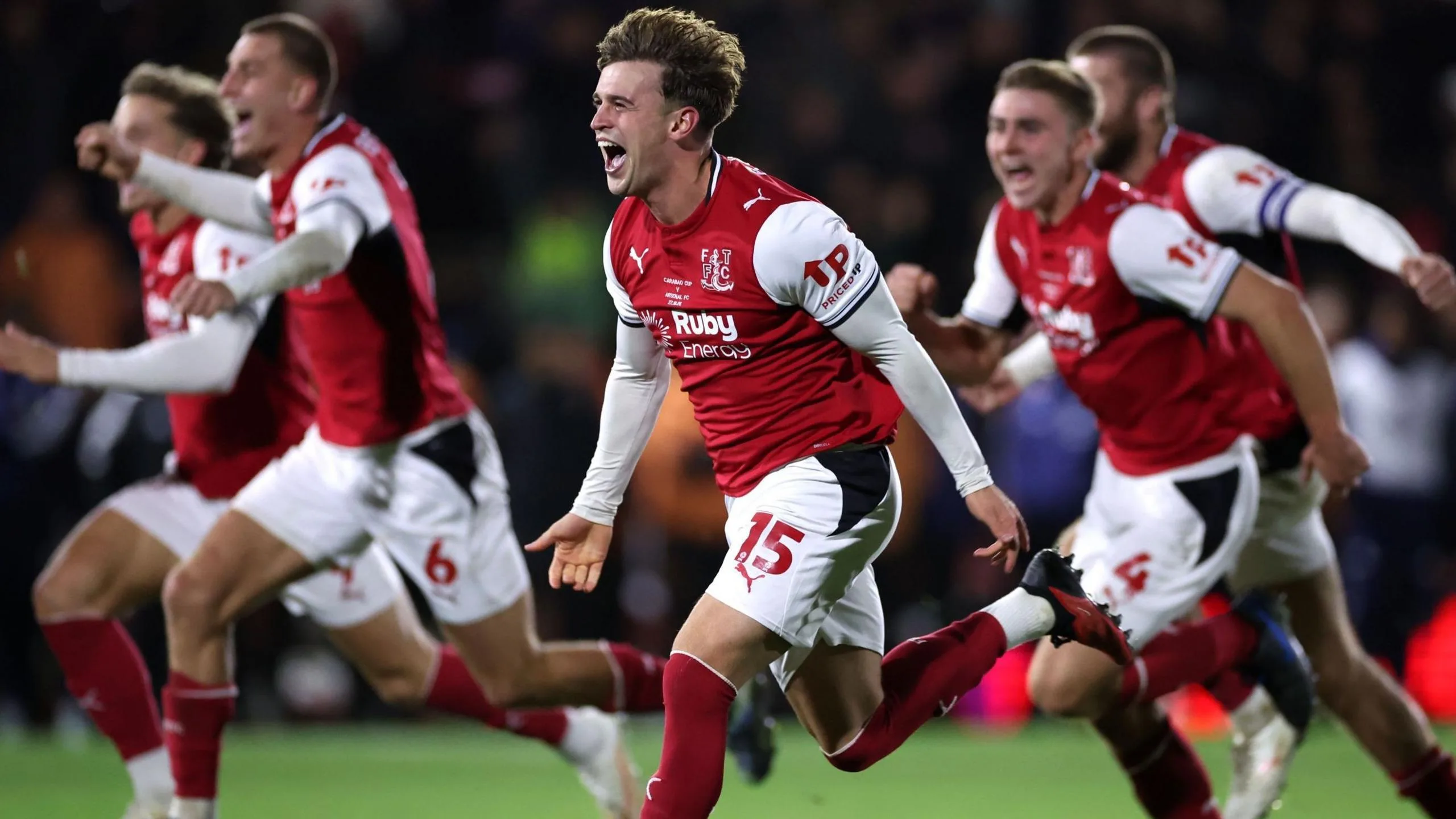 Fleetwood's players celebrate after beating Premier League champions Arsenal in the League Cup fourth round