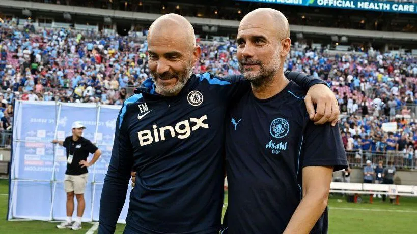 A smiling Enzo Maresca and Pep Guardiola chat after a pre-season friendly between Chelsea and Manchester City in the USA in 2024