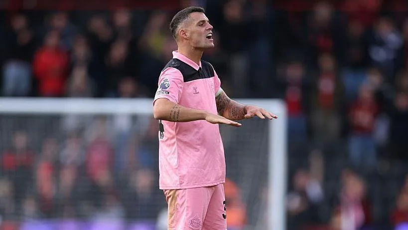 Sunderland midfielder Granit Xhaka, in pink kit, makes a palms-down gesture with both hands at full-time following the Bournemouth game