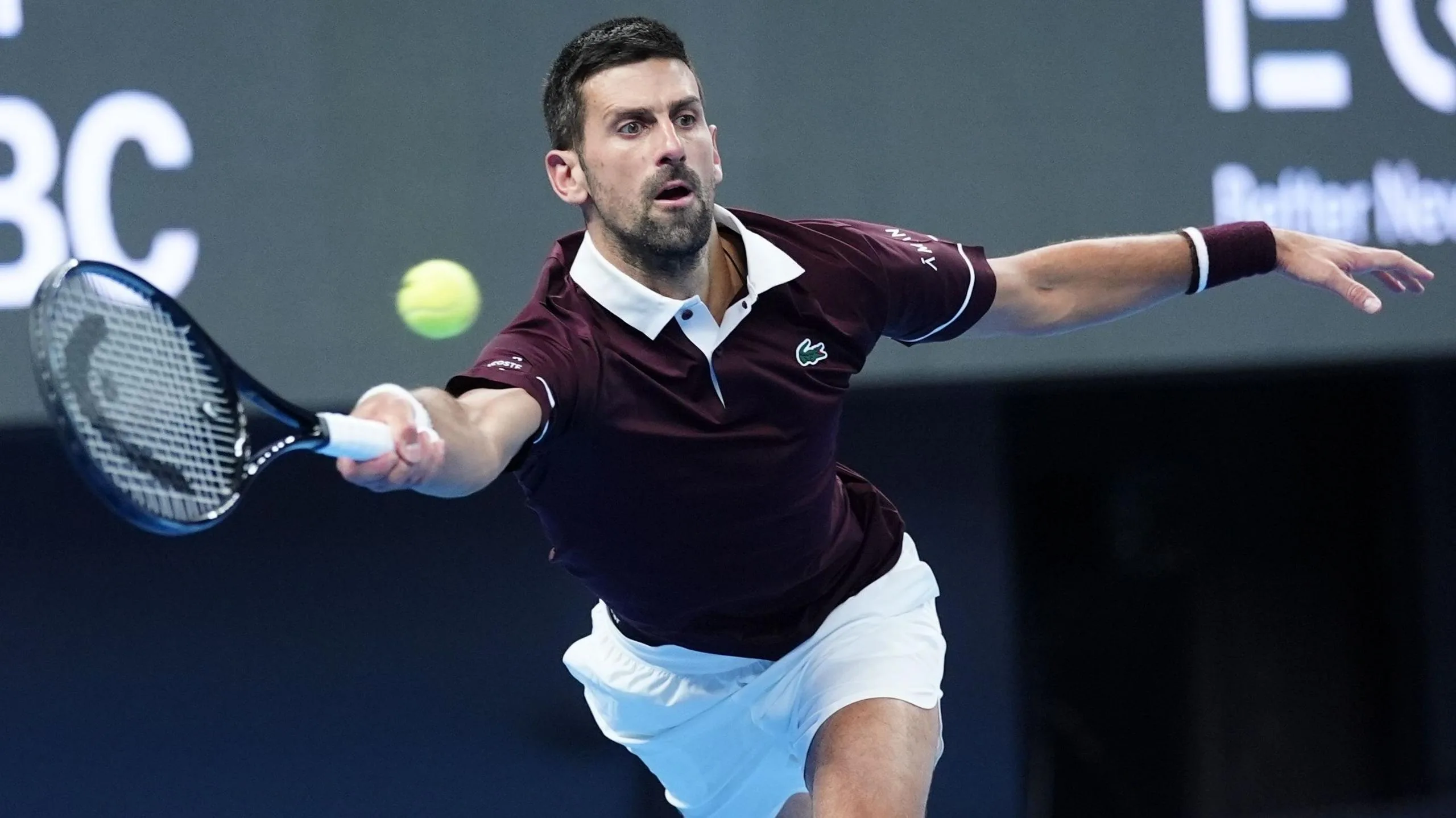 Novak Djokovic stretches to hit a forehand stroke during his quarter-final victory over Alexander Zverev