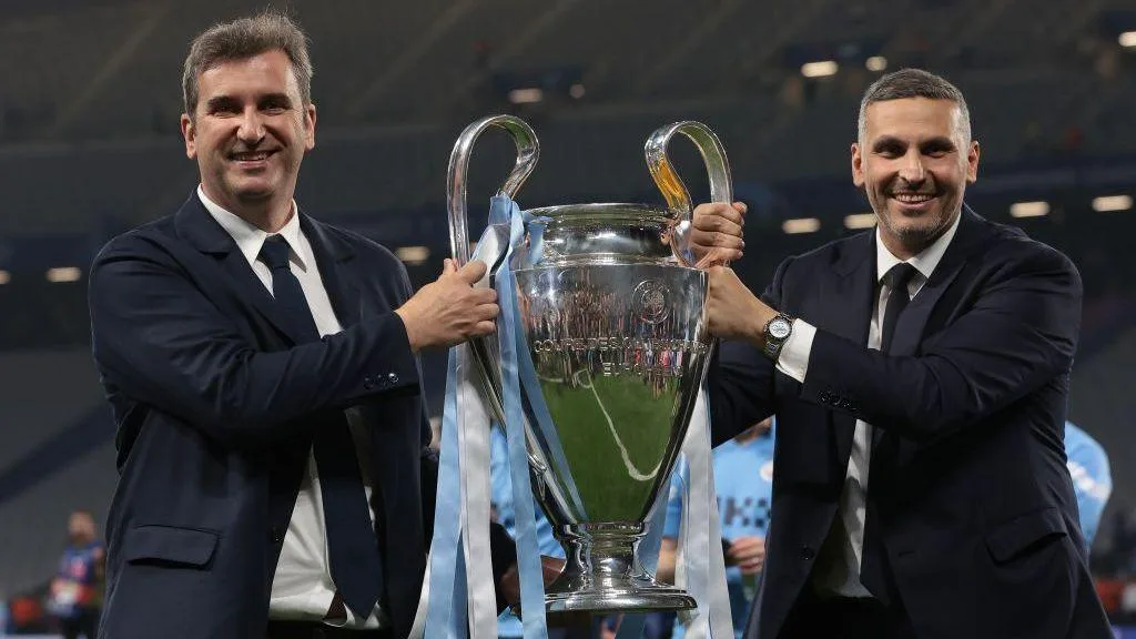 Ferran Soriano and Khaldoon Al Mubarak hold the Champions League trophy in 2023