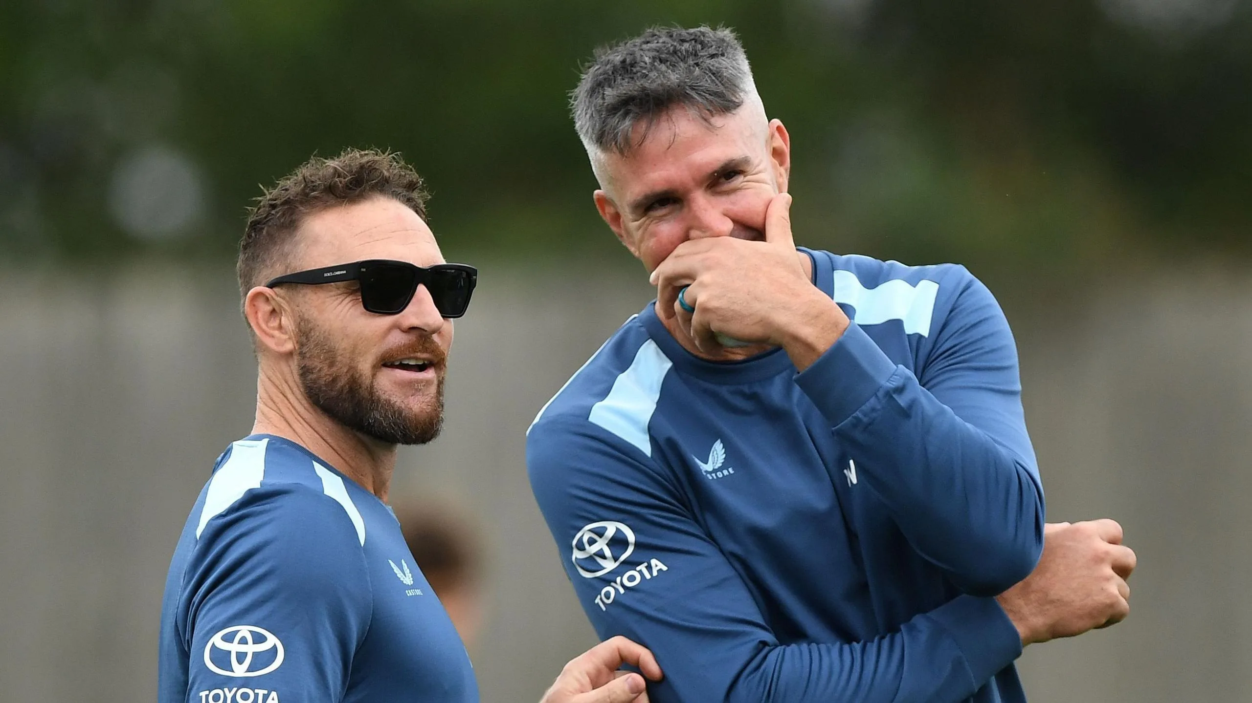 Brendon McCullum and Kevin Pietersen share a joke during an England training session