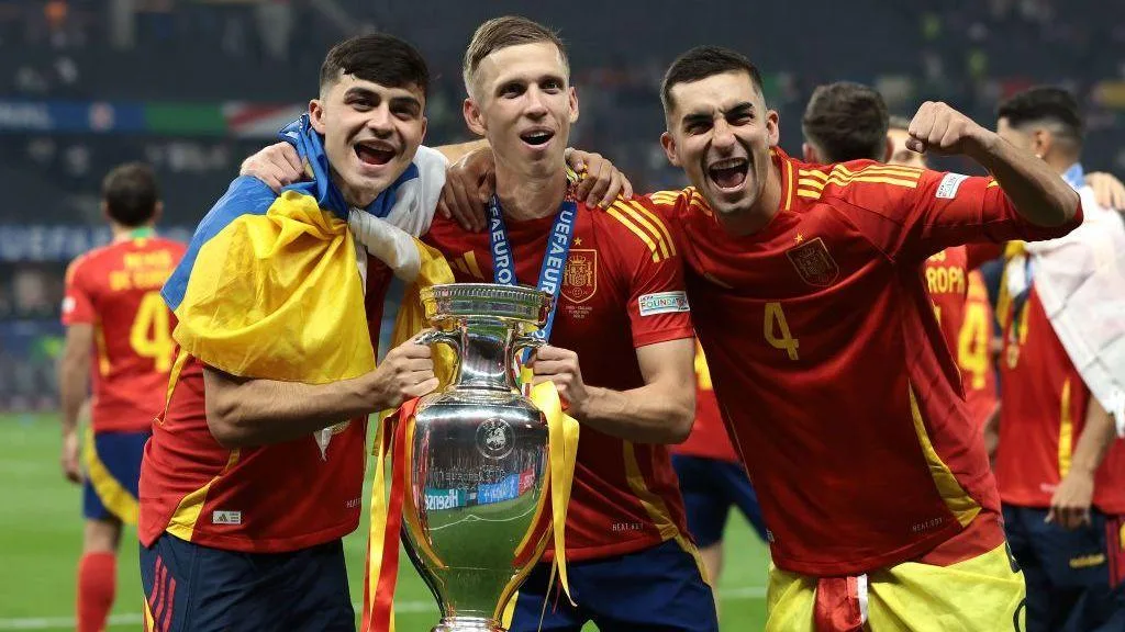 Pedri, Dani Olmo and Ferran Torres holding the Euro 2024 trophy