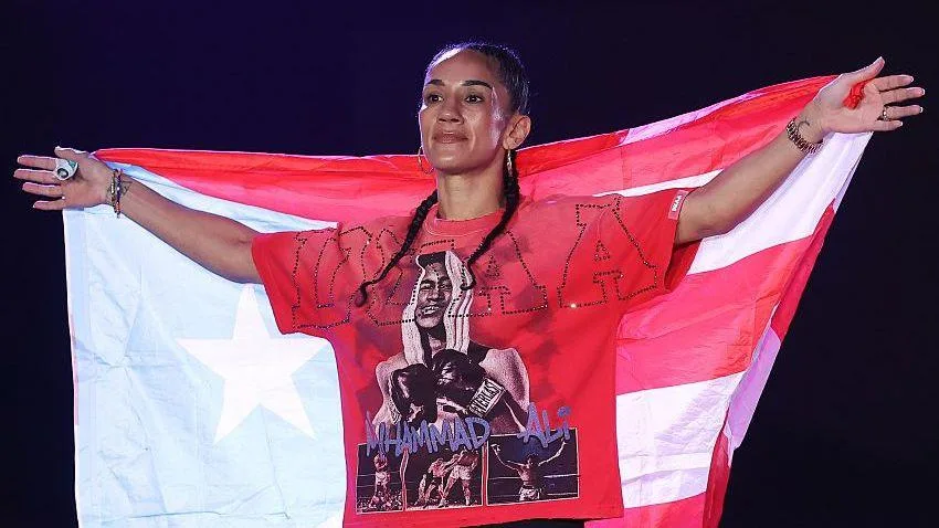 Amanda Serrano poses on the scale at a weigh-in 