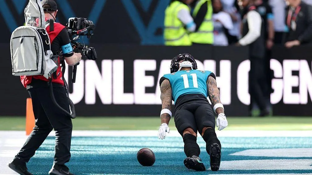 Parker Washington celebrates by pretending to be knocked out