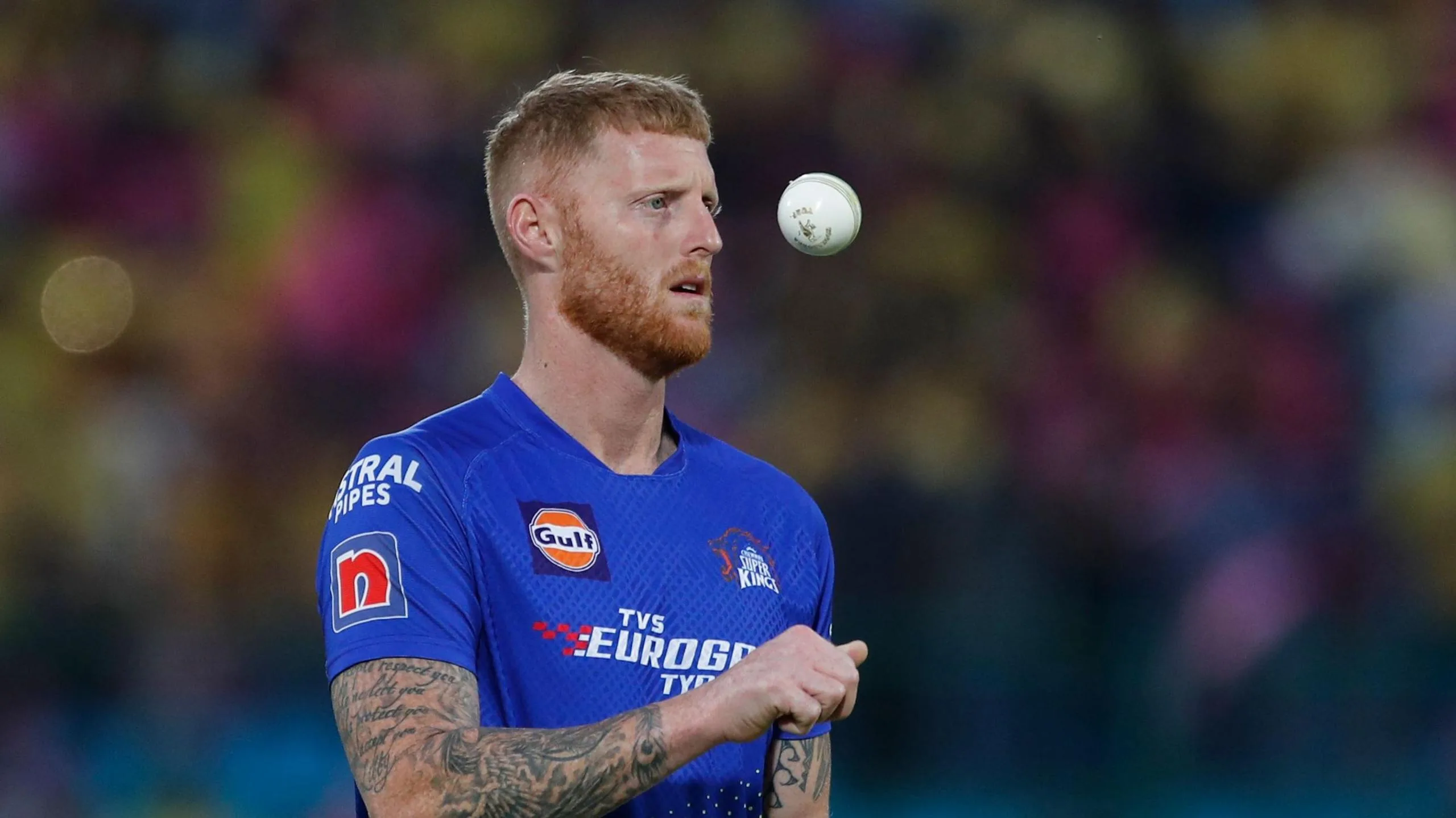 Ben Stokes throwing the white ball up as he prepares to start his bowling run-up for Chennai Super Kings