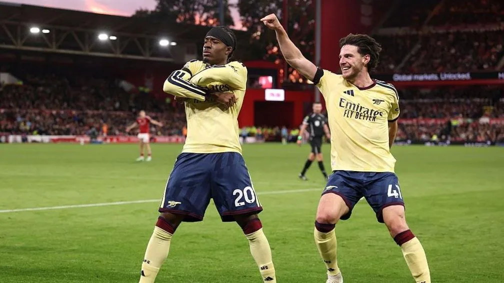 Noni Madueke celebrates with Declan Rice.