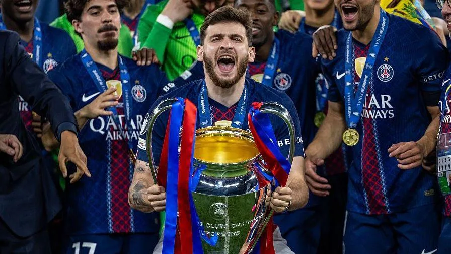 Khvicha Kvaratskhelia with the Champions League trophy