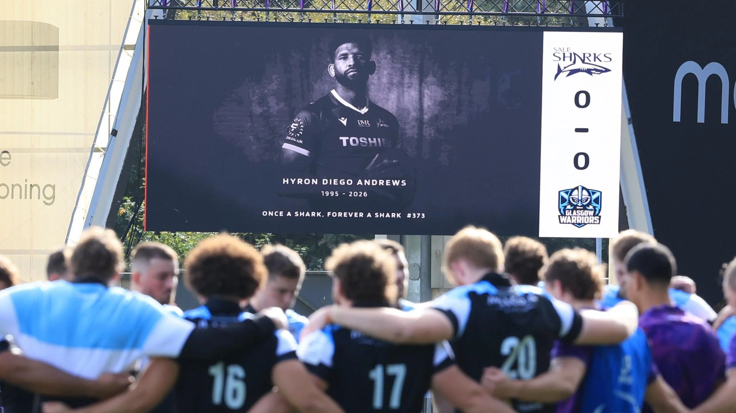 A tribute to Hyron Andrews is shown on a big screen at Sale's match with Glasgow