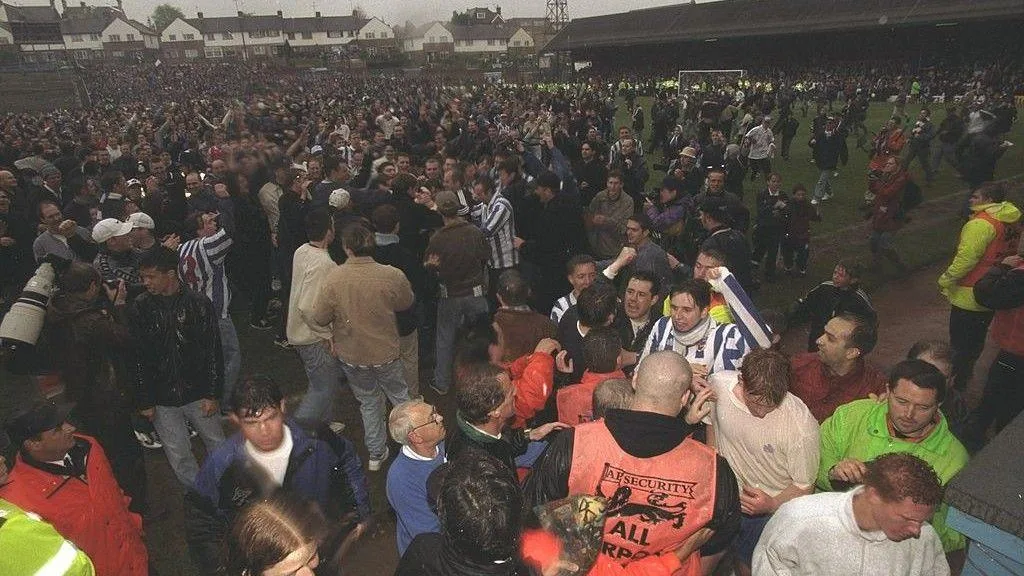 Brighton fans run onto the pitch after the final match at the Goldstone Ground in April 1997