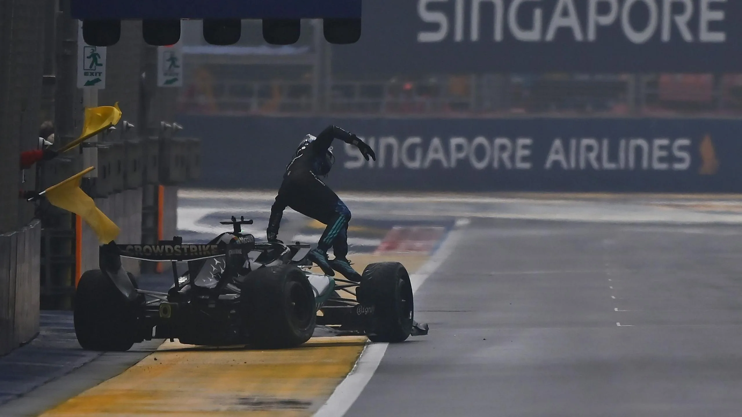 George Russell climbs out of his Mercedes after crashing on the first lap of the Singapore Grand Prix sprint race