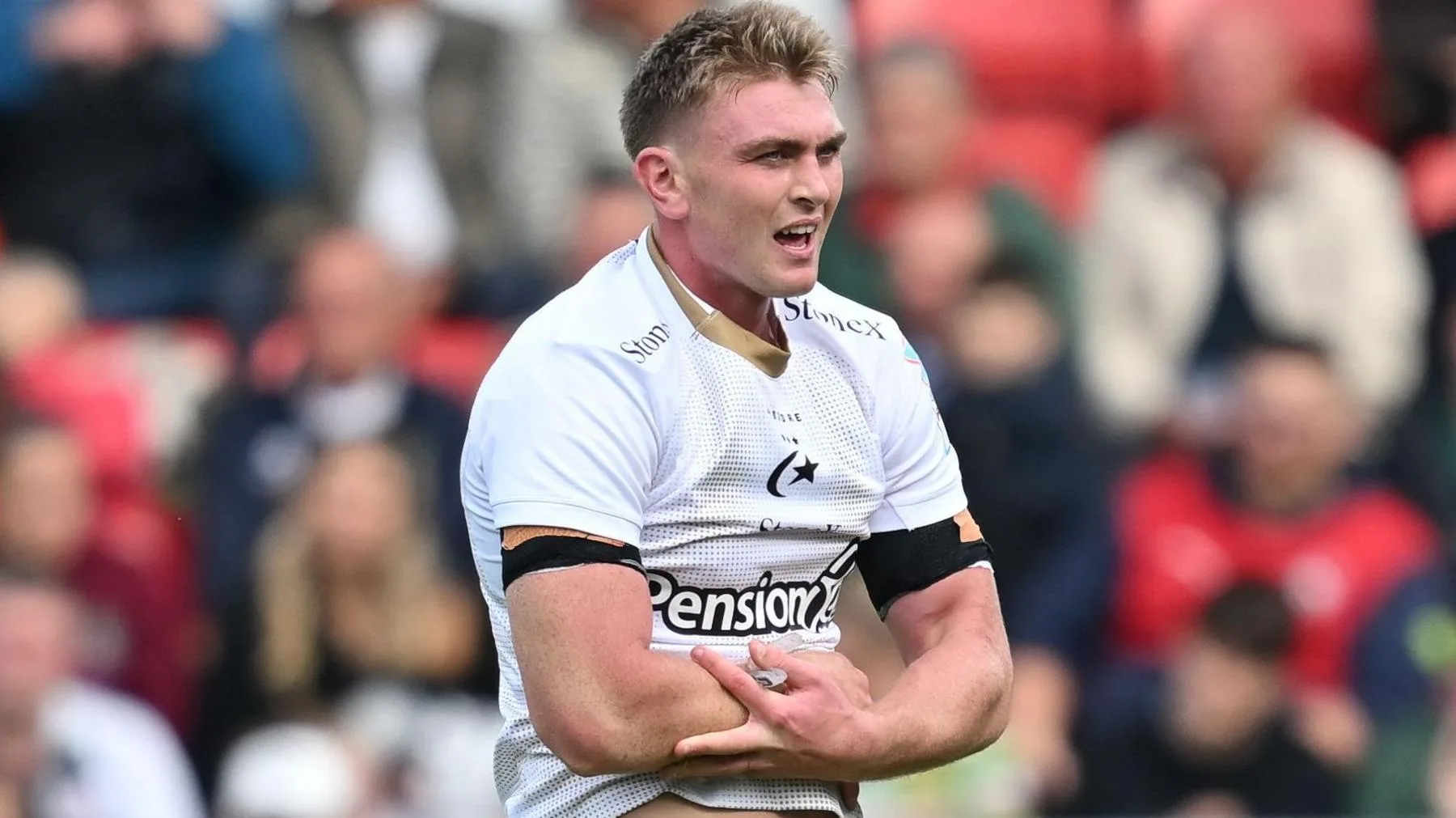 Olly Hartley holds his arm as he comes off injured
