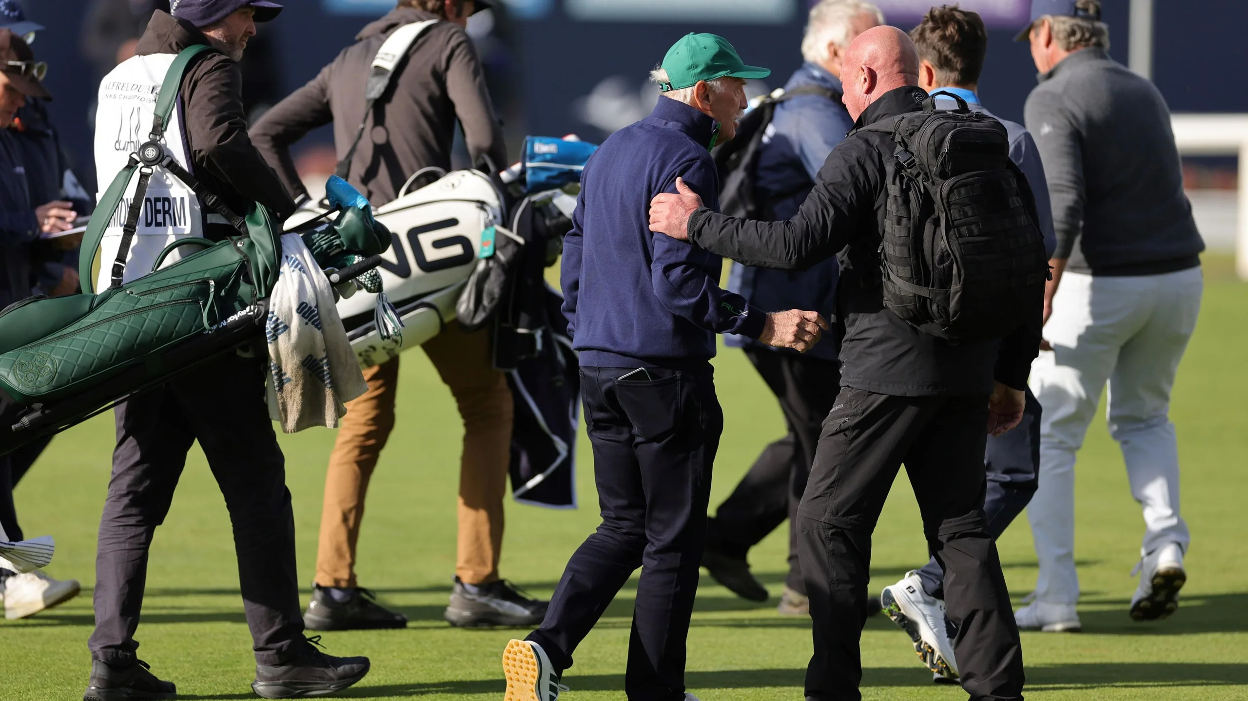Dermot Desmond being escorted off the golf course by security