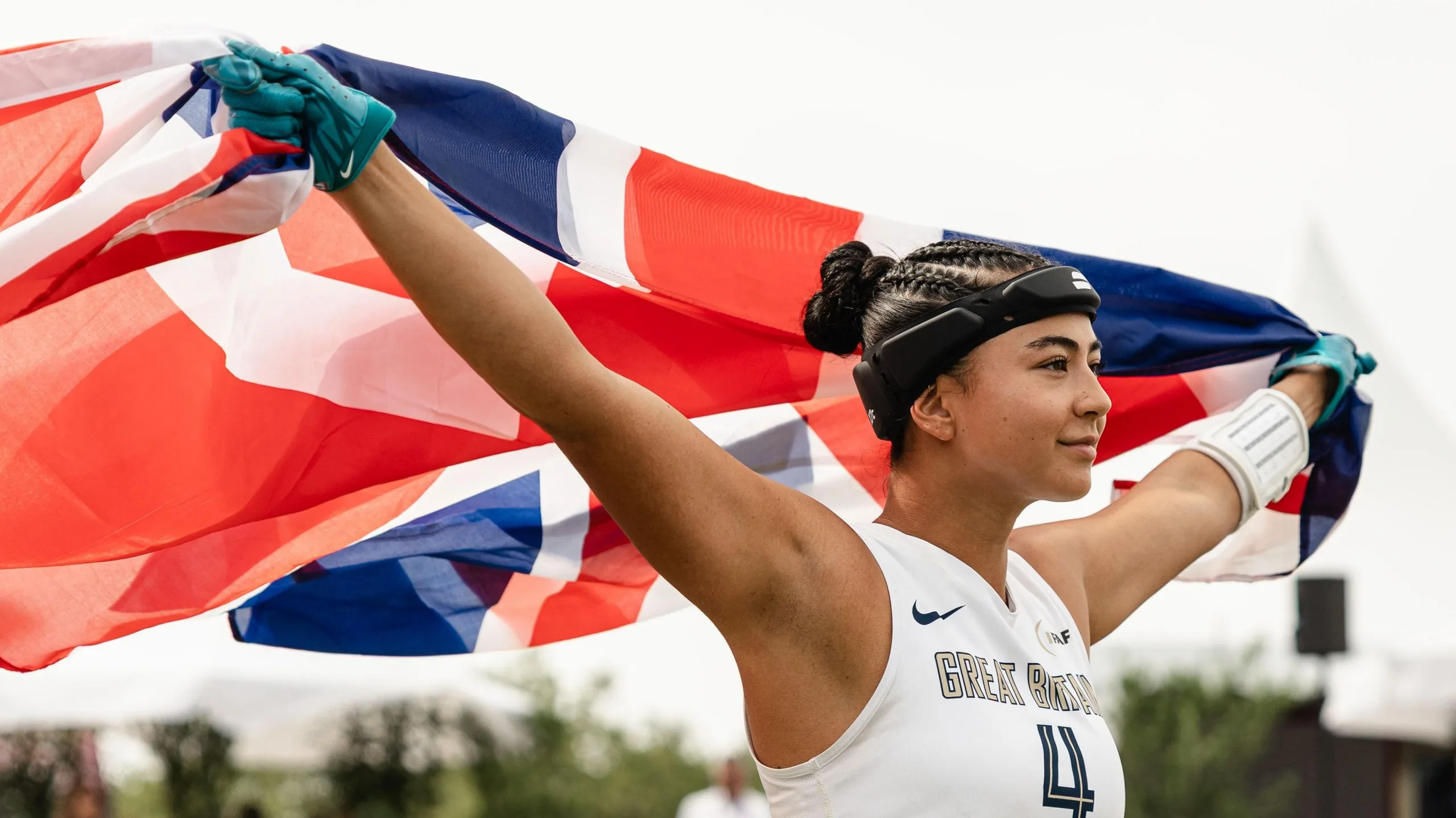 Angelica Tait holds a Great Britain flag aloft during the 2026 Flag Football World Championships