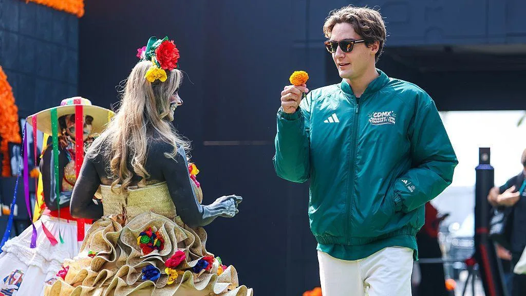 George Russell is handed a flower in the Mexico City paddock