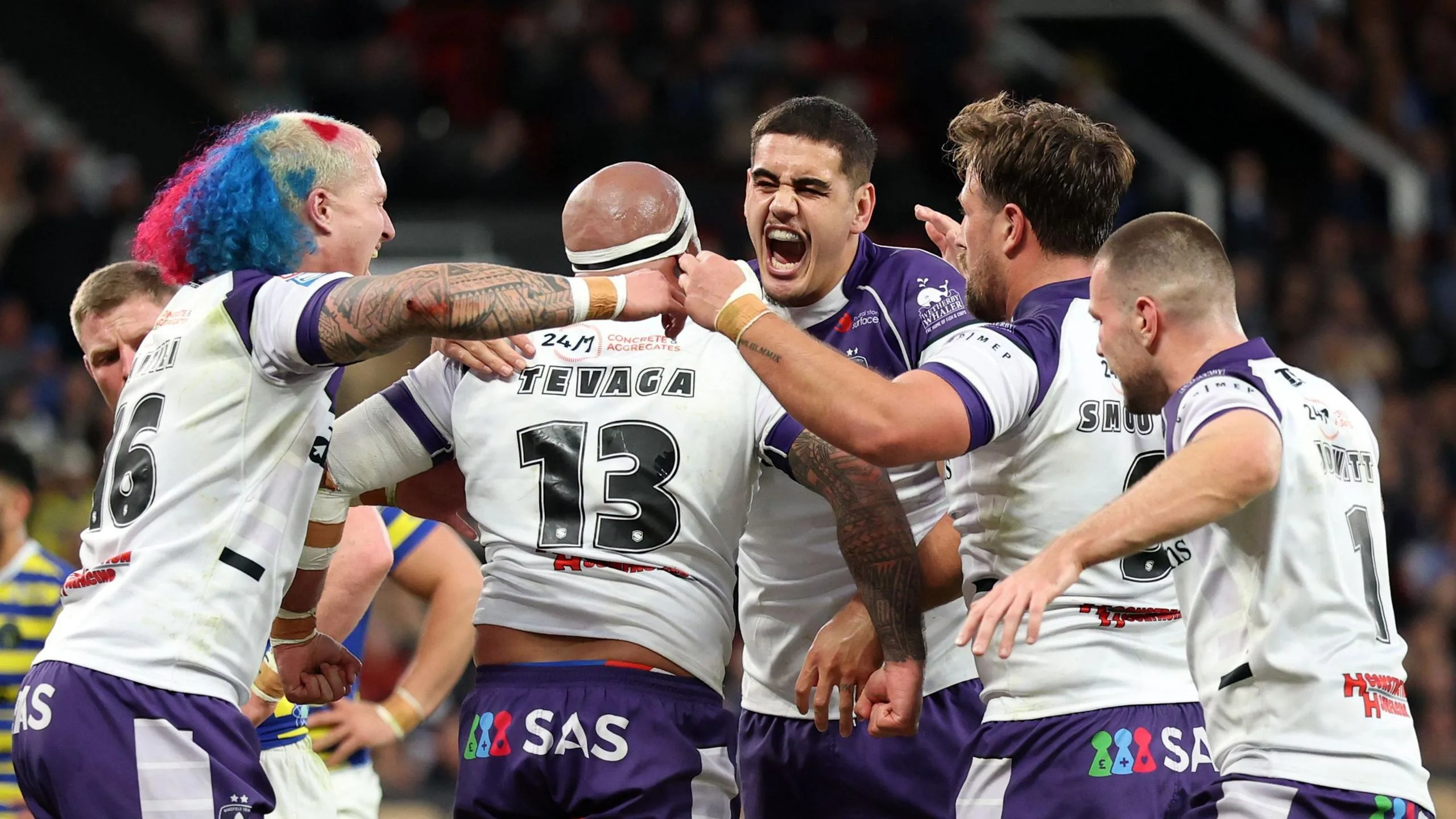 Wakefield players congratulate Jazz Tevaga (13) after his try against Warrington