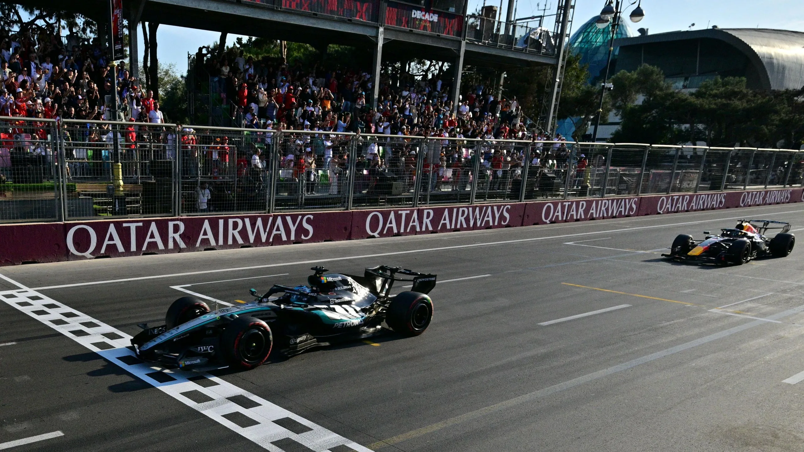 Mercedes' George Russell crosses the finish line with Red Bull's Max Verstappen just behind to win the Azerbaijan Grand Prix