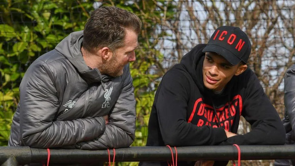 Former Liverpool player Trent Alexander-Arnold chatting with academy director Alex Inglethorpe