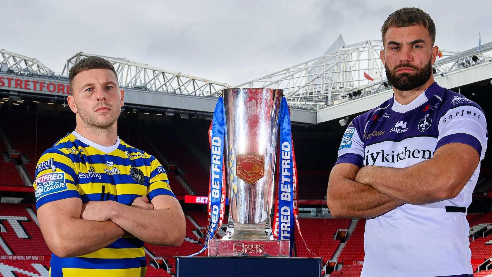 Warrington Wolves' George Williams and Wakefield Trinity's Mike McMeeken stand alongside the Super League trophy at Manchester United's Old Trafford