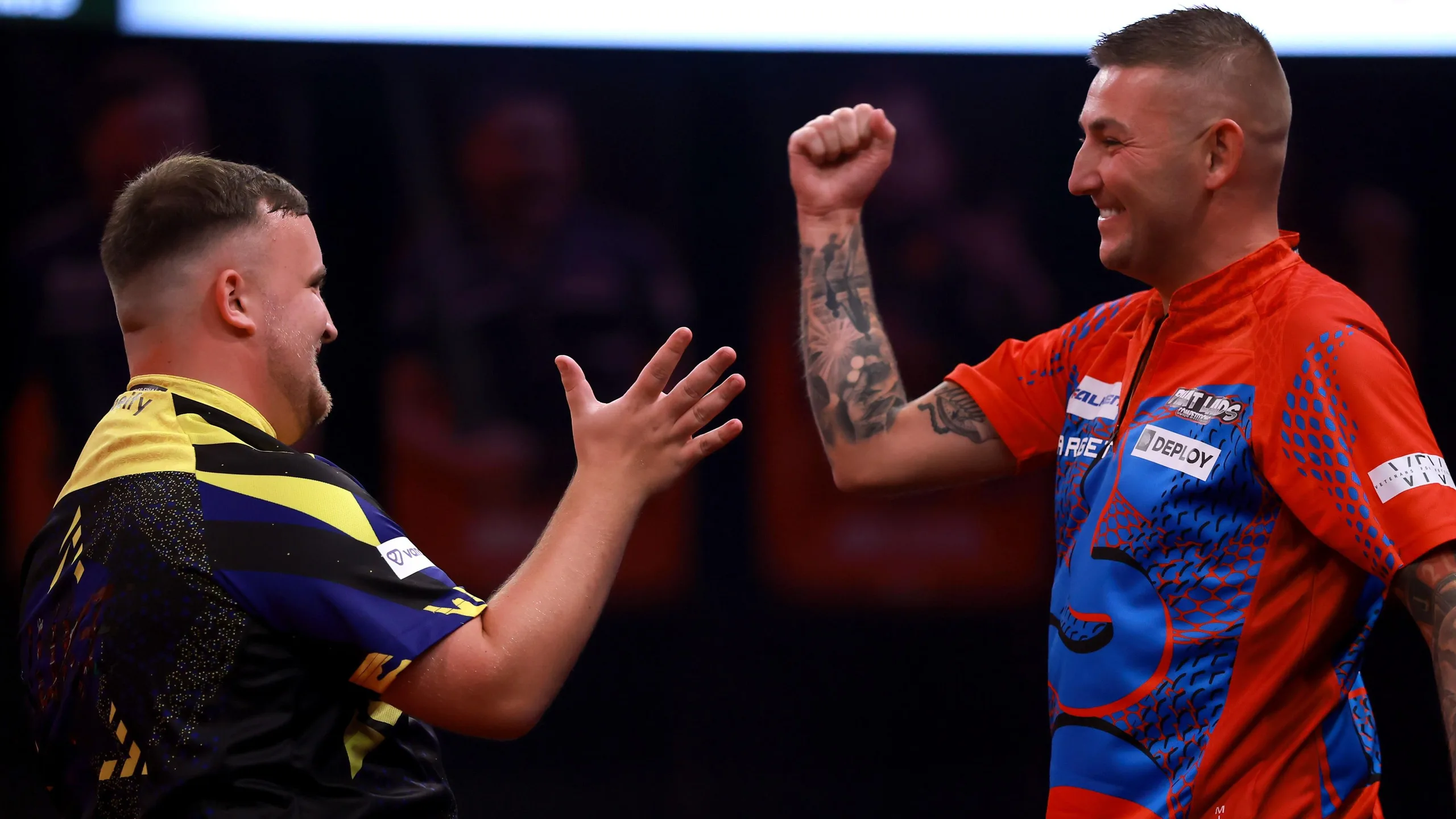 Luke Littler and Nathan Aspinall prepare to shake hands at the end of their match