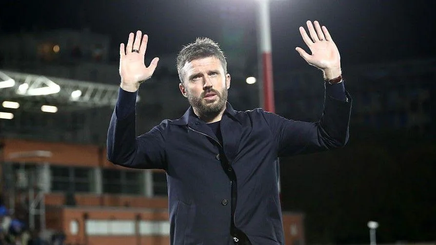 Manchester United head coach Michael Carrick acknowledges the club's fans after the 4-1 defeat by Como