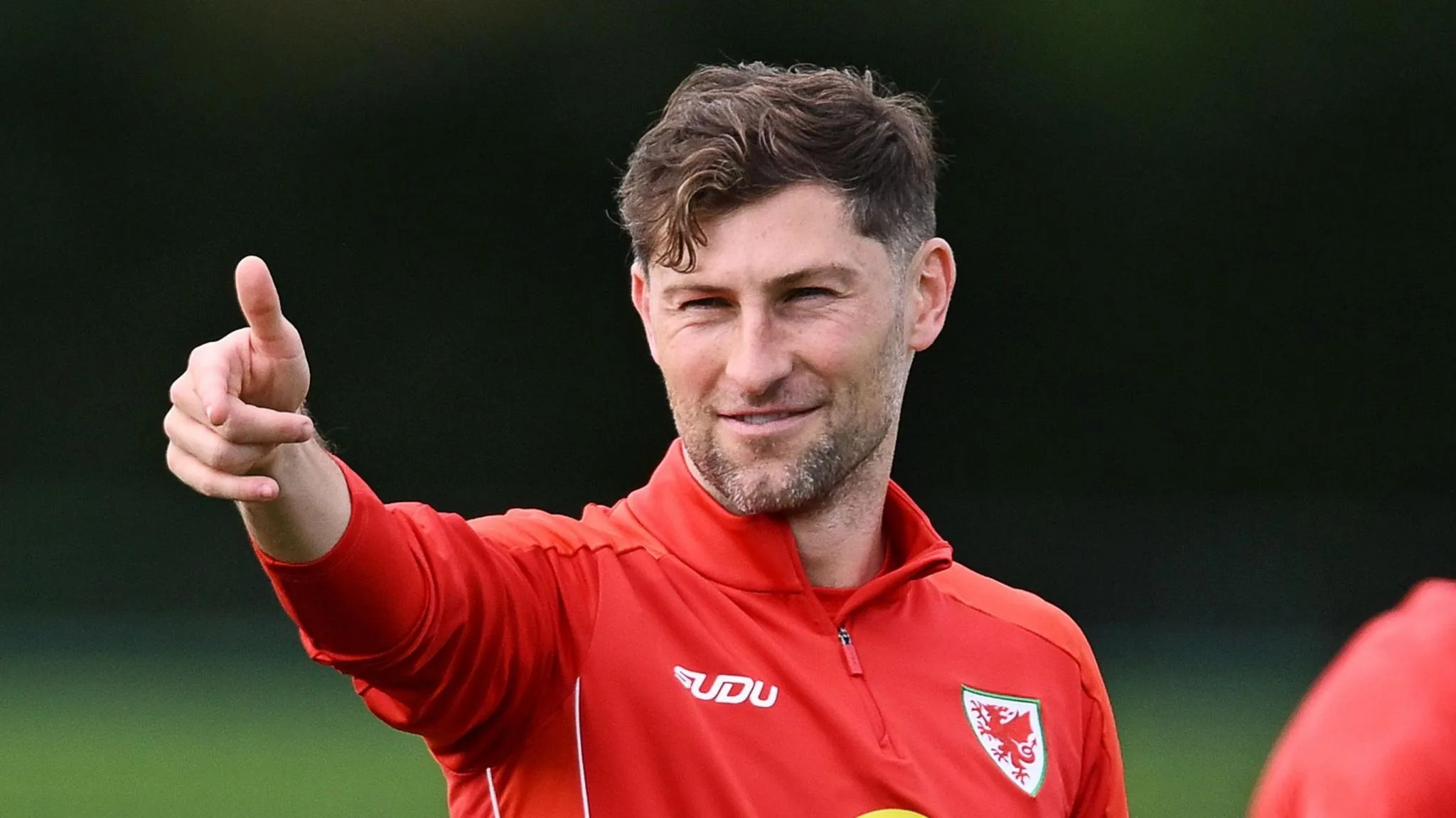 Ben Davies points during Wales training