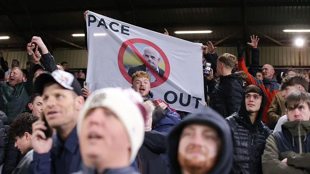 Burnley supporters protest against their owners with a flag during the Championship against Wolverhampton Wanderers