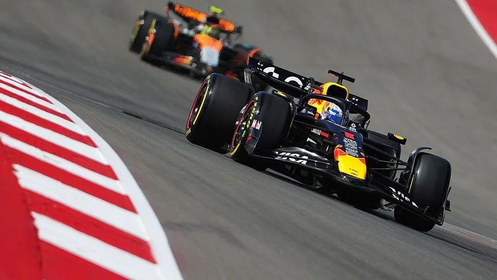 Lando Norris behind Max Verstappen on track in Austin last year 
