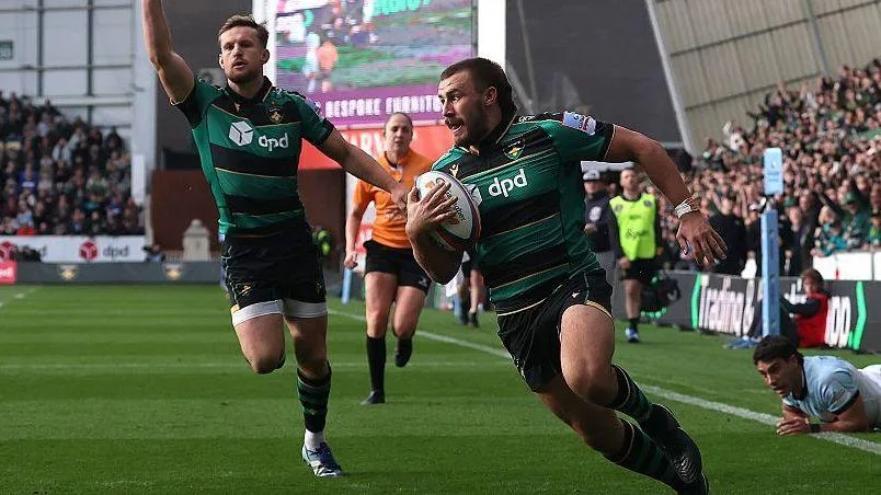 Ollie Sleightholme runs over the try line with the ball tucked under his right arm to his body as a team-mate runs in celebration behind