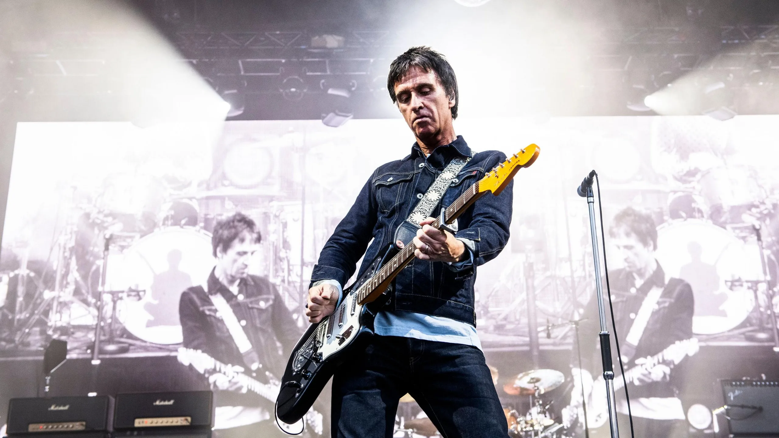 A picture of Johnny Marr playing at his gig at Castlefield Bowl in Manchester in July