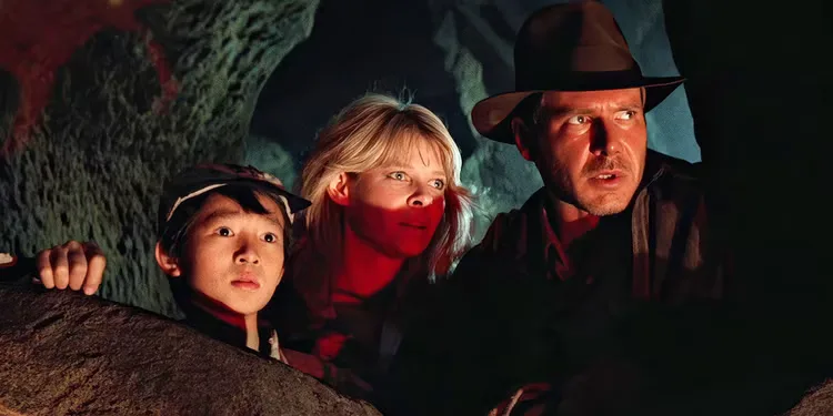 Ke Huy Quan, Kate Capshaw and Harrison Ford watch Amrish Puri's Mola Ram from the caves of Indiana Jones and the Temple of Doom.
