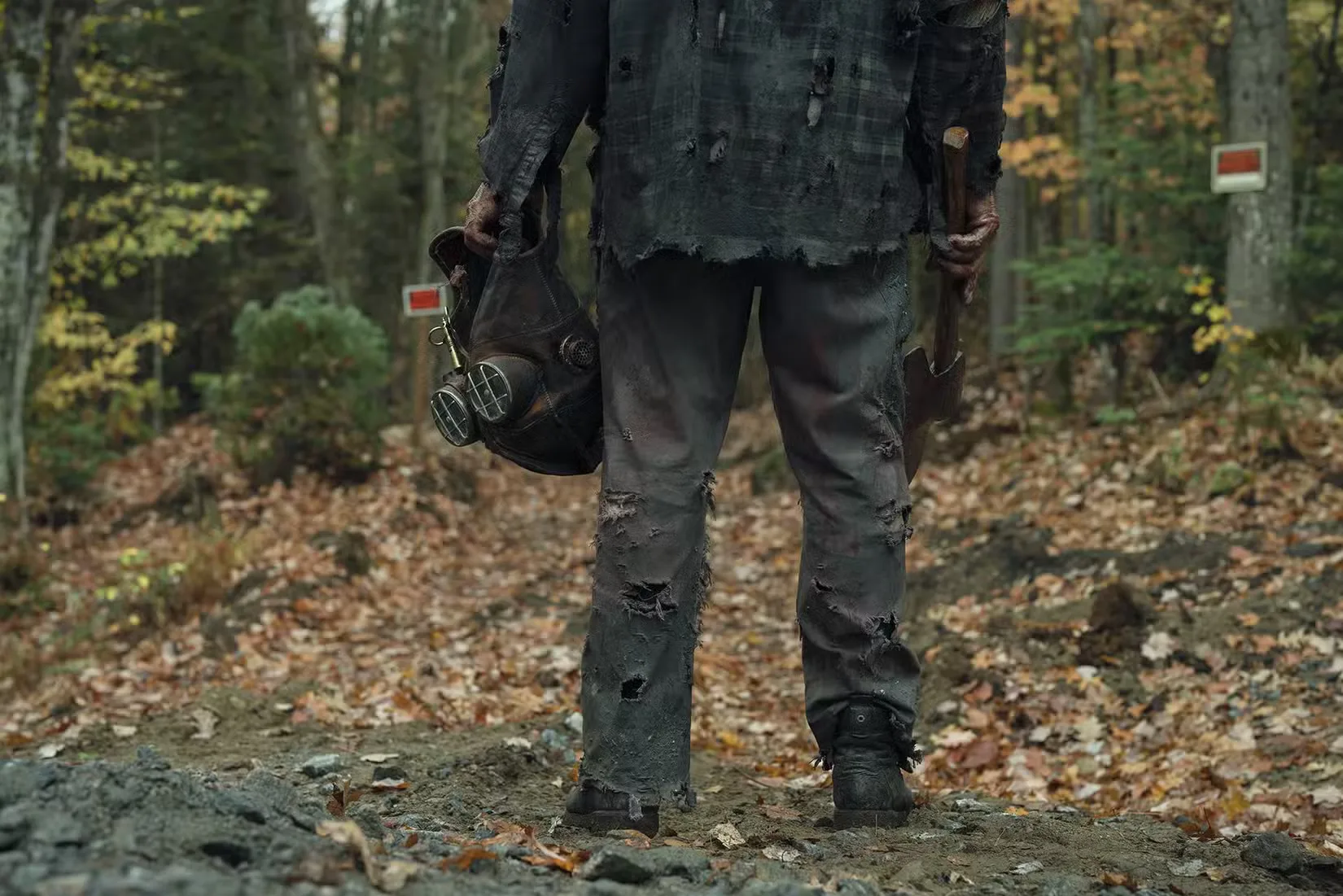 The bottom half of Ry Barrett as the slasher killer Johnny in the woods in In a Violent Nature: Part 2