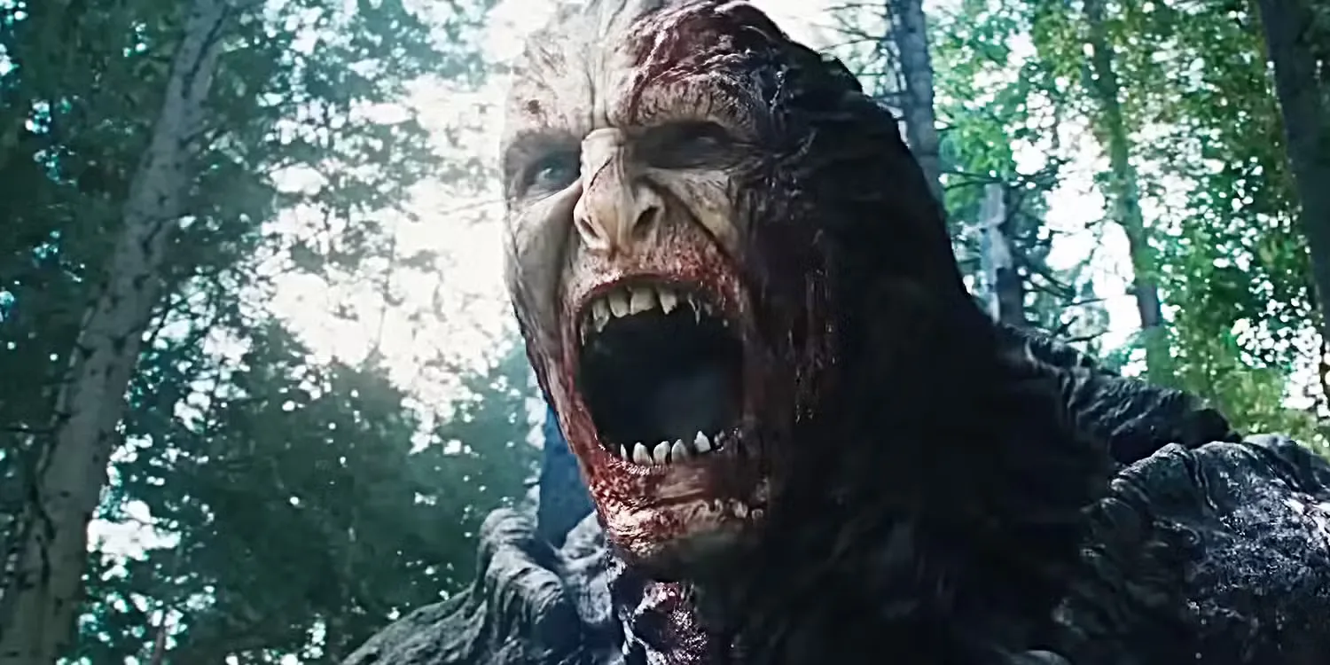 Alien monster screams with bared sharp teeth in a heavily wooded forest in a scene from the sci-fi thriller Hope
