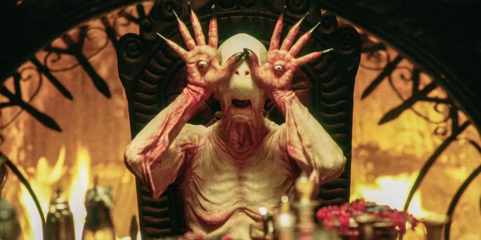 The Pale Man with his eyes in his palms sitting at a table in Pan's Labyrinth (2006)