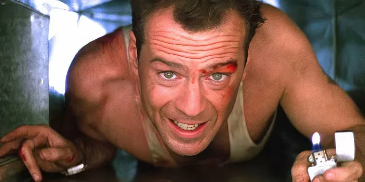 Bruce Willis, playing John McClane, crawls through a duct with a lighter in Die Hard. 