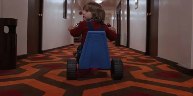 Danny tricycling down a long hallway in 'The Shining'