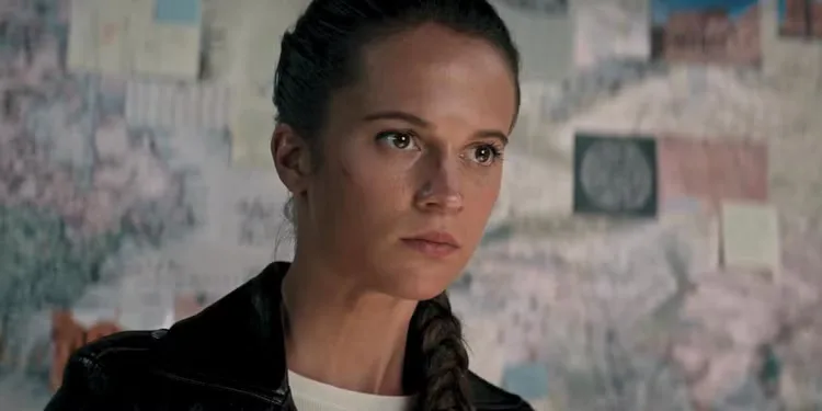 Lara Croft sorts through her father's research after solving a puzzle he left behind in Tomb Raider 2018