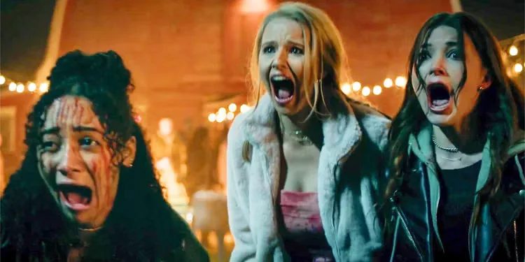 Verity Marks, Cassandra Potenza and Katie Douglas screaming at a carnival in Clown in a Cornfield