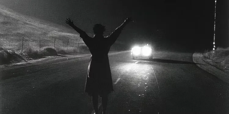A woman stopping a car at night in 'Kiss Me Deadly'