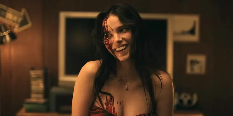 Nikki (Inde Navarrette) smiling with blood on her face and body in 'Obsession'