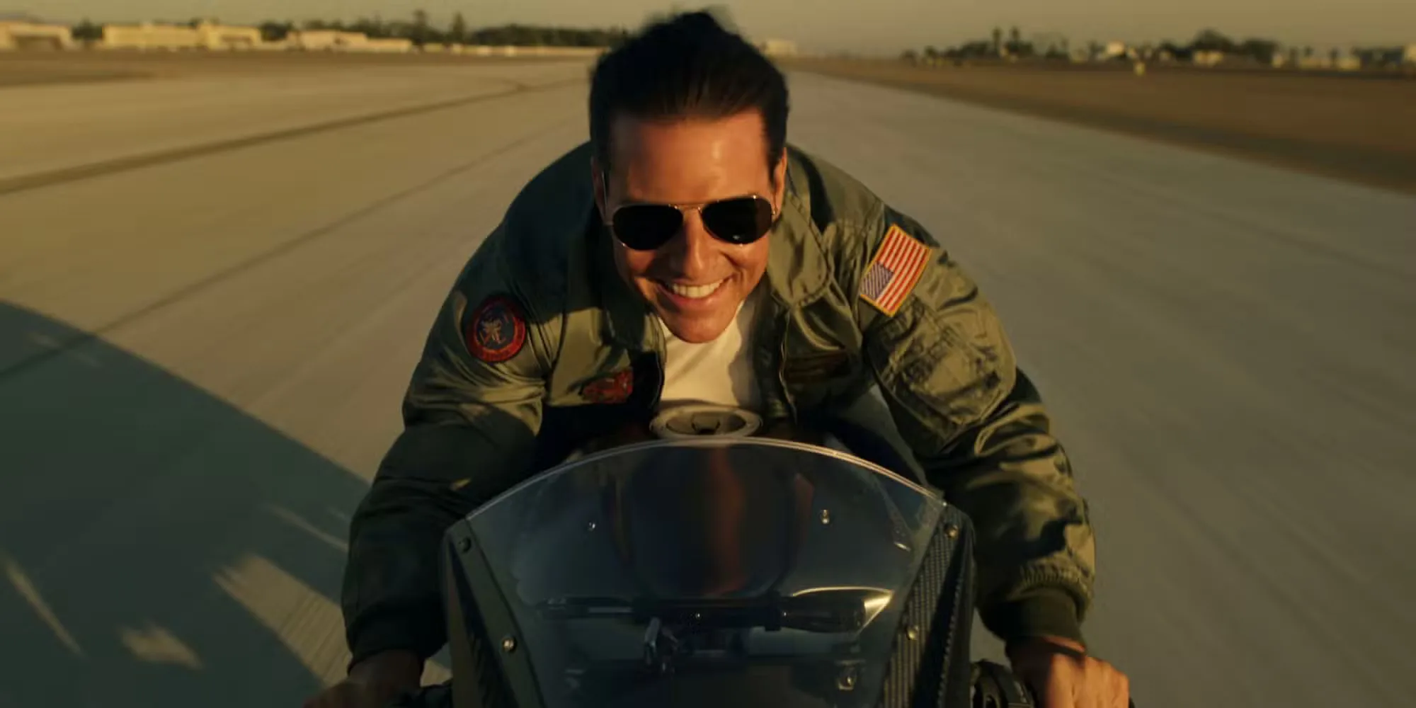 Tom Cruise driving a motorcycle at a high speed in Top Gun: Maverick (2022)