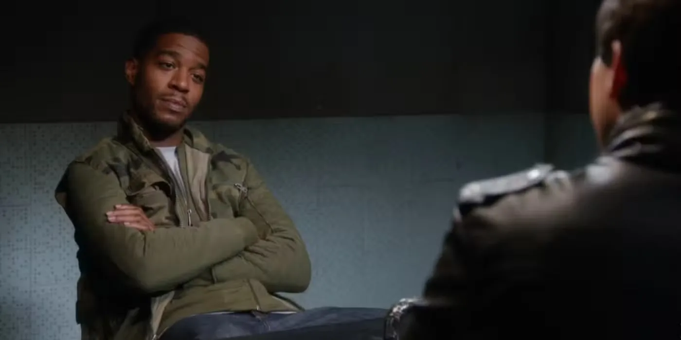 Dustin Whitman (played by Kid Cudi) sitting across from Jake Peralta (played by Andy Samberg), though you can only see some of Jake's back in "Brooklyn-Nine-Nine."
