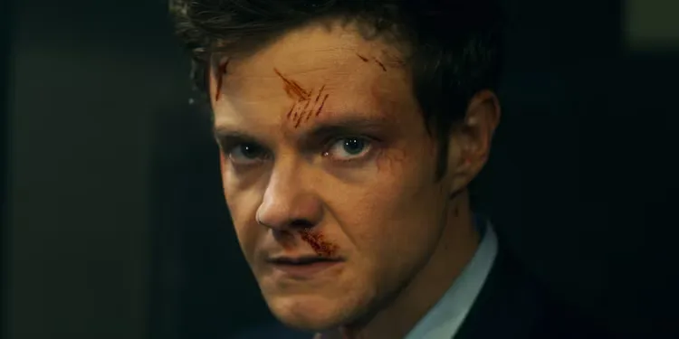 Jack Quaid as Nathan "Nate" Caine with scratches on his face in Novocaine