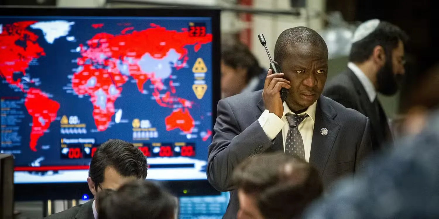 Fana Mokoena holding a satellite phone in World War Z.