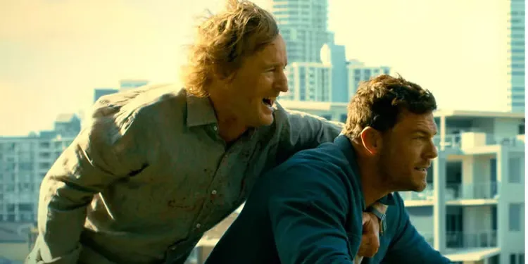 Alan Ritchson and Owen Wilson riding on a motorcycle in Runner