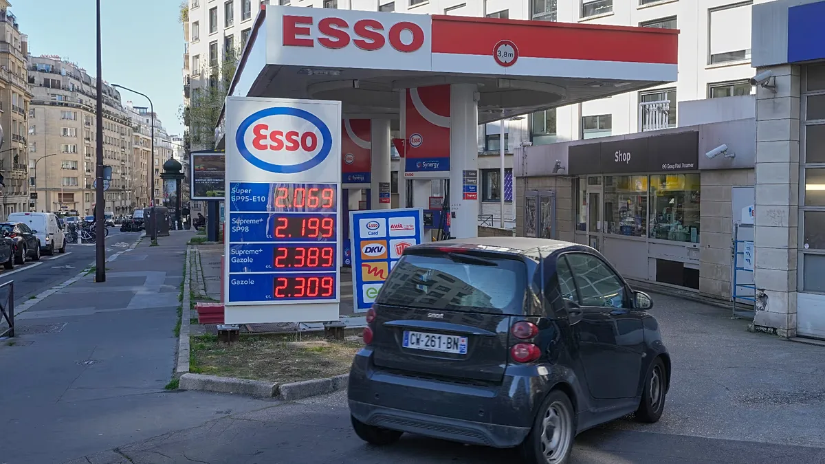 File - A car drives into a gas station as gasoline prices are displayed in Paris, Monday, 9 March 2026.