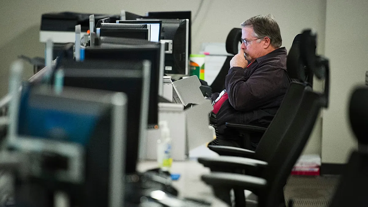 FILE. A person works on a computer at the Department of Homeland Security's National Cybersecurity and Communications Integration Center in Arlington, Virginia, Aug. 2018
