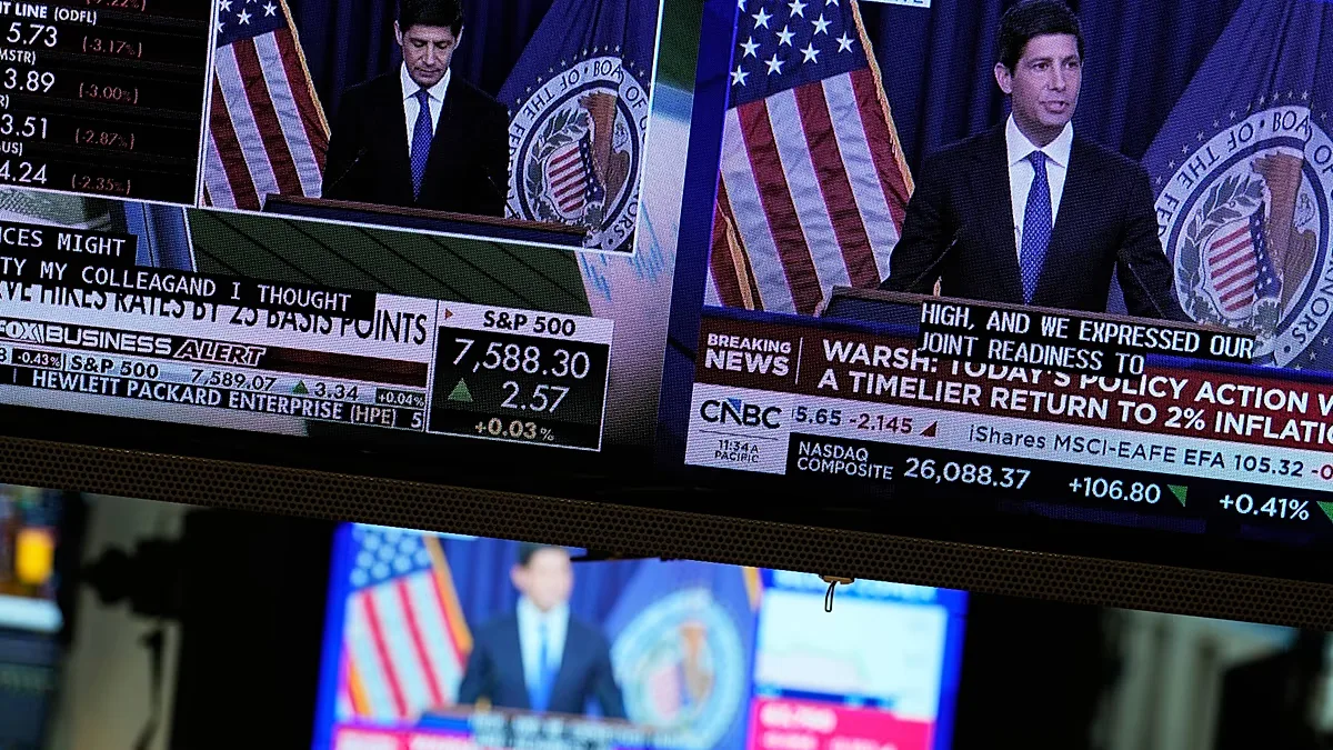 FILE. Screens display the news conference held by Federal Reserve chairman Kevin Warsh on the floor of the New York Stock Exchange, 16 Sept. 2026